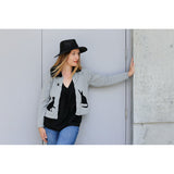 You are pert and pretty in a charming vintage-inspired cardigan. Smooth 100% cotton intarsia embellishes this soft knit, featuring two playful cats reaching for an embroidered butterfly. Accentuated by a detachable FAKE fur trim collar, appliqued elbow patches and delicate pearl buttons, this retro look inspires.  Heather grey with black pattern and collar.  100% cotton Detachable fur collar buttons on/off Appliquéd elbow patches Hand wash or machine wash gentle cycle Front button closure