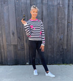 This graphic striped pullover features contrasting pink hearts artfully tossed. 100% soft cotton is in a fine gauge jacquard, suitable for all seasons. Details include jewel neck, long sleeves, and rib trims. Choose: Black/Off-White Stripe has bright pink hearts and neck trim. or Black/Grey Heather Stripe has pale pink hearts and neck trim. 100% softest cotton Rib trims Fine gauge jacquard Machine wash cold, lay flat to dry. Hearts and Stripes sweater