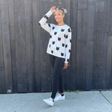 Our best seller is back!  Cats, not dots, adorn our pullover sweater in a soft, fine gauge cotton.  Jewel neckline and long sleeves complete the look.  Mid-hip length.  Choose:    Black ground with Off-white cats or  Off-white ground with black cats.  100% softest cotton Rib trims Fine gauge jacquard Machine wash cold, lay flat to dry.