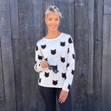 Our best seller is back!  Cats, not dots, adorn our pullover sweater in a soft, fine gauge cotton.  Jewel neckline and long sleeves complete the look.  Mid-hip length.  Choose:    Black ground with Off-white cats or  Off-white ground with black cats.  100% softest cotton Rib trims Fine gauge jacquard Machine wash cold, lay flat to dry.