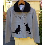 You are pert and pretty in a charming vintage-inspired cardigan. Smooth 100% cotton intarsia embellishes this soft knit, featuring two playful cats reaching for an embroidered butterfly. Accentuated by a detachable FAKE fur trim collar, appliqued elbow patches and delicate pearl buttons, this retro look inspires.  Heather grey with black pattern and collar.  100% cotton Detachable fur collar buttons on/off Appliquéd elbow patches Hand wash or machine wash gentle cycle Front button closure