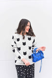 Our best seller is back!  Cats, not dots, adorn our pullover sweater in a soft, fine gauge cotton.  Jewel neckline and long sleeves complete the look.  Mid-hip length.  Choose:    Black ground with Off-white cats or  Off-white ground with black cats.  100% softest cotton Rib trims Fine gauge jacquard Machine wash cold, lay flat to dry.
