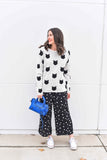 Our best seller is back!  Cats, not dots, adorn our pullover sweater in a soft, fine gauge cotton.  Jewel neckline and long sleeves complete the look.  Mid-hip length.  Choose:    Black ground with Off-white cats or  Off-white ground with black cats.  100% softest cotton Rib trims Fine gauge jacquard Machine wash cold, lay flat to dry.
