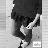 Cable peplum sweater black.Delicate cables in an off-center pattern decorate this roomy fine gauge cotton sweater with a faux leather peplum trim.  This soft pullover has long sleeves and a jewel neckline.  Peplum fabric pattern may vary from pictured.  Only in black.  100% softest cotton Rib trims Fine gauge cable Faux leather peplum